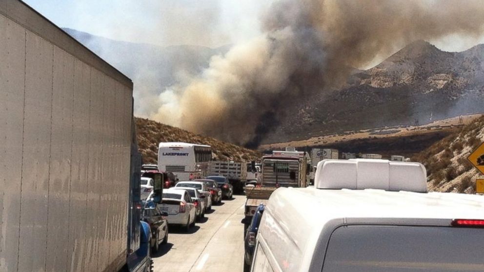 PHOTO: Smoke from a wildfire rises above Interstate 15 on the Cajon Pass, Friday, July 17, 2015, near San Bernadino, Calif., as a fast-moving wildfire swept across the Southern California freeway.