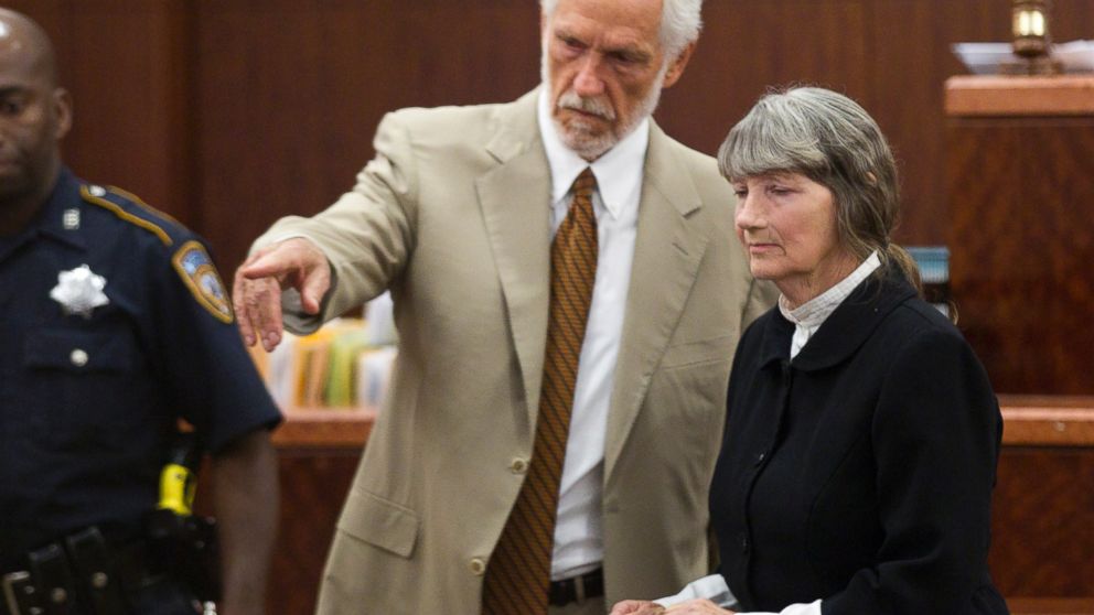 PHOTO: Attorney James Stafford, left, shows Carolyn Krizan-Wilson, right, to her seat as she appears in court, Oct. 23, 2013, in Houston.
