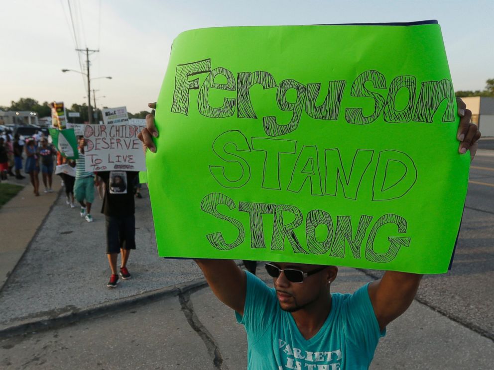 PHOTO: People march to protest the shooting of Michael Brown, Aug. 20, 2014, in Ferguson, Mo.