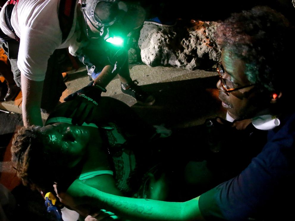 PHOTO: People help a woman sprayed with chemicals after police attempted to disperse a protest in Ferguson, Mo., Aug. 20, 2014.