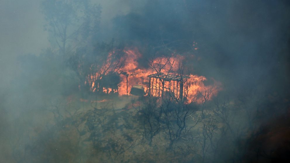 PHOTO: The skeleton shell of a home is engulfed in flames, May 15, 2014, in San Marcos, Calif.