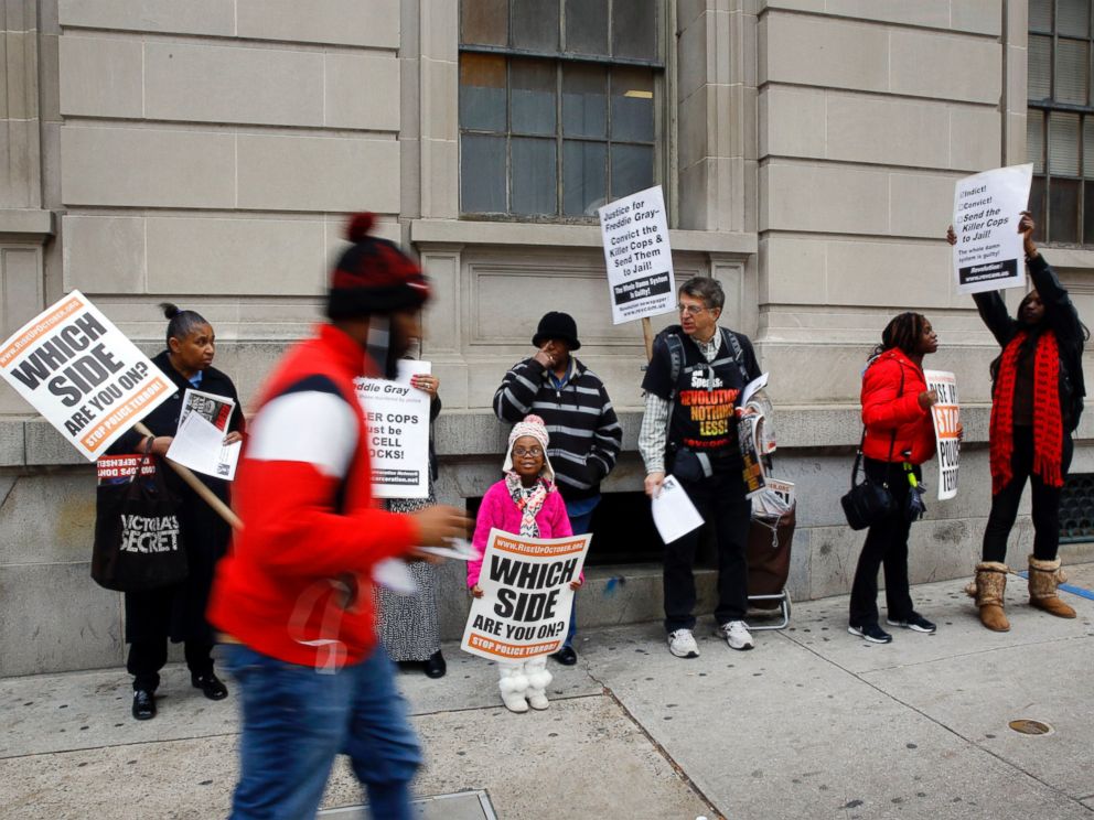 PHOTO: A group of protesters stand outside a courthouse as jury deliberations continue for the trial of Officer William Porter, one of six Baltimore city police officers charged in connection to the death of Freddie Gray, Dec. 16, 2015, in Baltimore.
