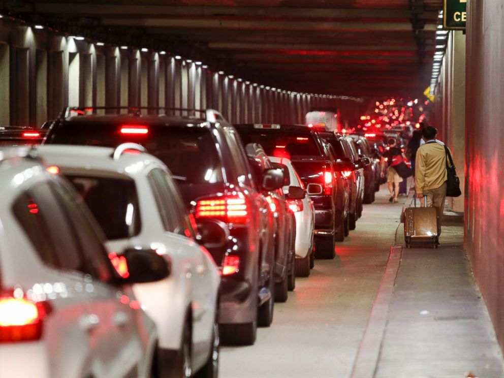PHOTO: Passengers pull their luggage and walk toward Los Angeles International Airport, Sunday, Aug. 28, 2016.