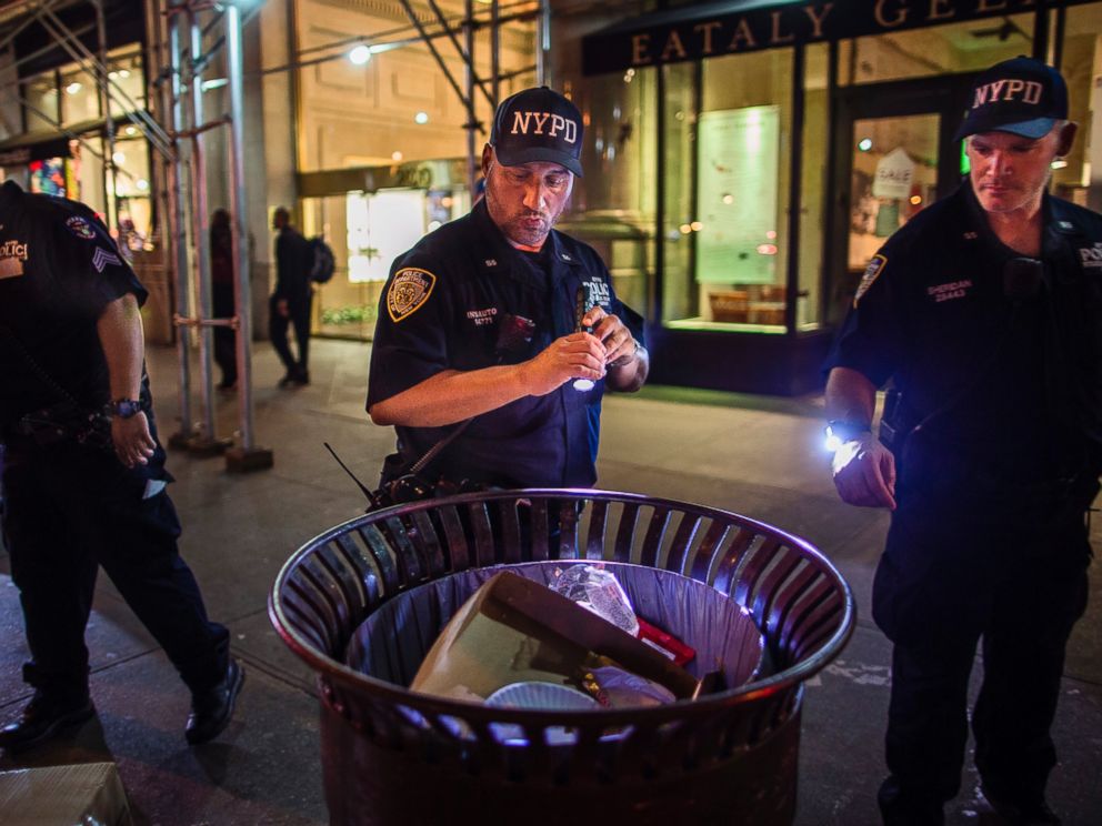 PHOTO: Police officers look for suspicious packages along Fifth Avenue near the scene of an explosion on West 23rd Street and 6th Avenue in Manhattans Chelsea neighborhood, in New York, Sept. 18, 2016.