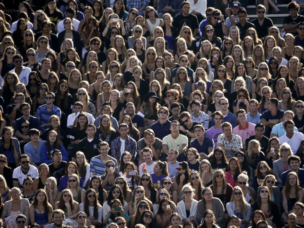 PHOTO: People listen to a memorial service at Harder Stadium on the campus of University of California, Santa Barbara, May 27, 2014.