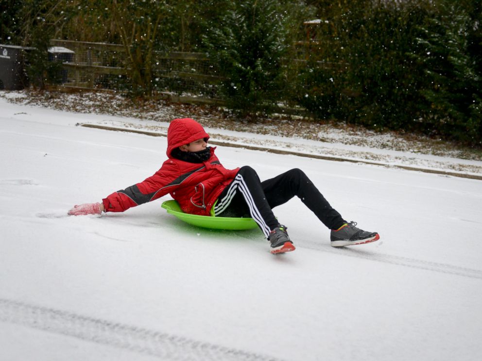 PHOTO: Pablo Hortal, 11, sleds down a street in Winston-Salem, N.C. as snow falls, Feb. 16, 2015.