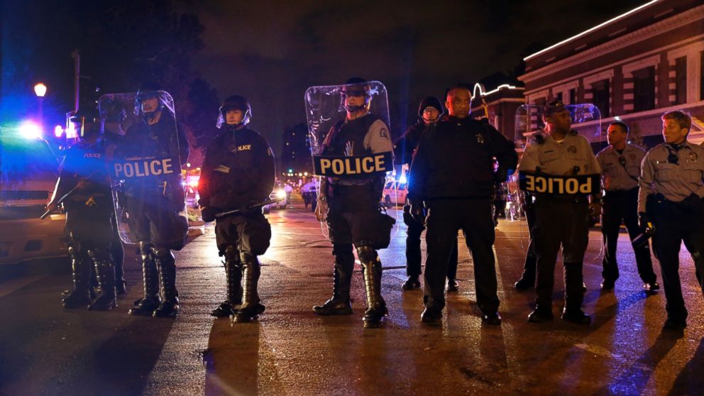 PHOTO: Police wearing riot gear form a line to contain protesters in St. Louis, Oct. 9, 2014.
