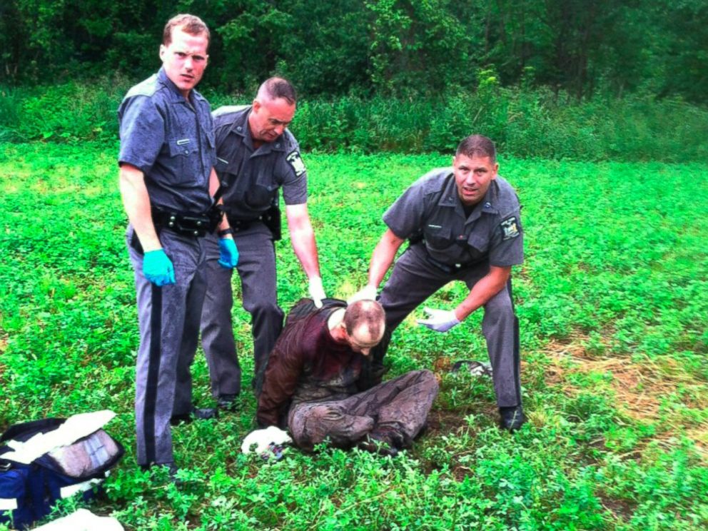 PHOTO: Police stand over David Sweat after he was shot and captured near the Canadian border Sunday, June 28, 2015, in Constable, N.Y.