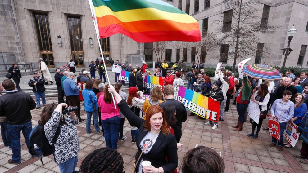 PHOTO: A woman holds a flag as she joins other gay marriage supporters in Linn Park, at the Jefferson County courthouse, Feb. 9, 2015, in Birmingham, Ala.