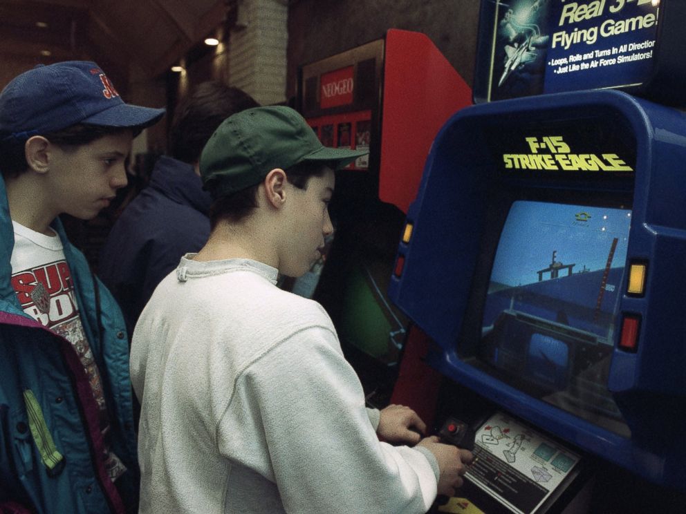 PHOTO: Raymond Freda plays the new F-15 Strike Eagle video game at an arcade in New York in this Jan. 28, 1991, file photo as his friend Brian Valenza looks on.