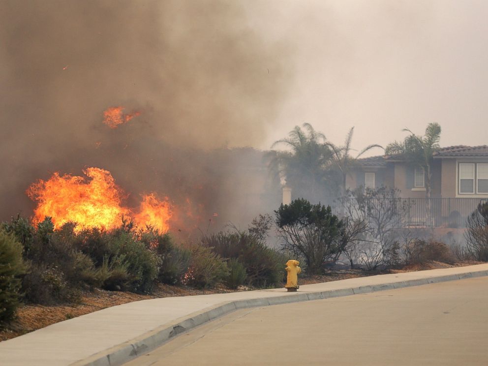 PHOTO: A wildfire climbs a canyon toward homes, May 14, 2014, in Carlsbad, Calif.