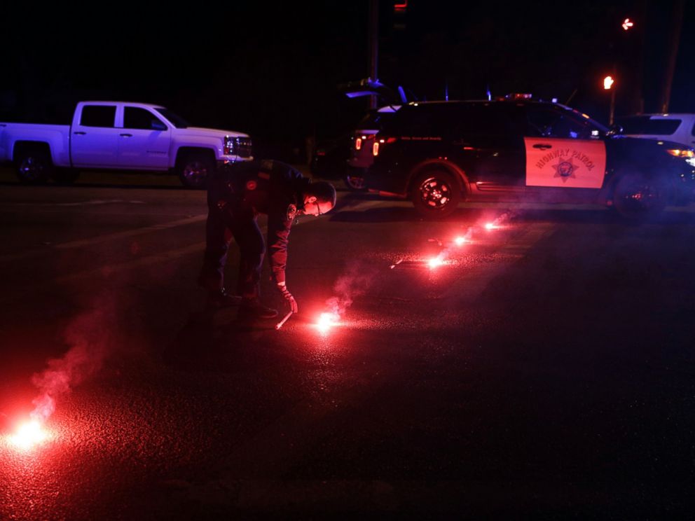 PHOTO: A police officer lights up flares near the scene where a shootout took place, Dec. 2, 2015, in San Bernardino, Calif.