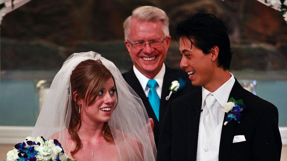 PHOTO: Aurora shooting survivors, and now newlyweds, Eugene and Kirstin Han smile at each other after exchanging vows during their wedding ceremony at Village East Baptist Church, in Aurora, Colo. Saturday July 20, 2013.