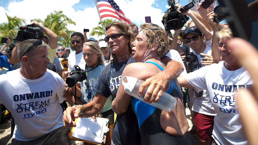PHOTO: Endurance swimmer Diana Nyad, right, and her trainer, Bonnie Stoll hug after Nyad walks ashore, Sept. 2, 2013, in Key West, Fla. after swimming from Cuba.