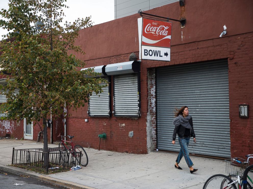 PHOTO: A pedestrian walks past The Gutter bowling alley in the Williamsburg neighborhood of New York on Friday, Oct. 24, 2014.