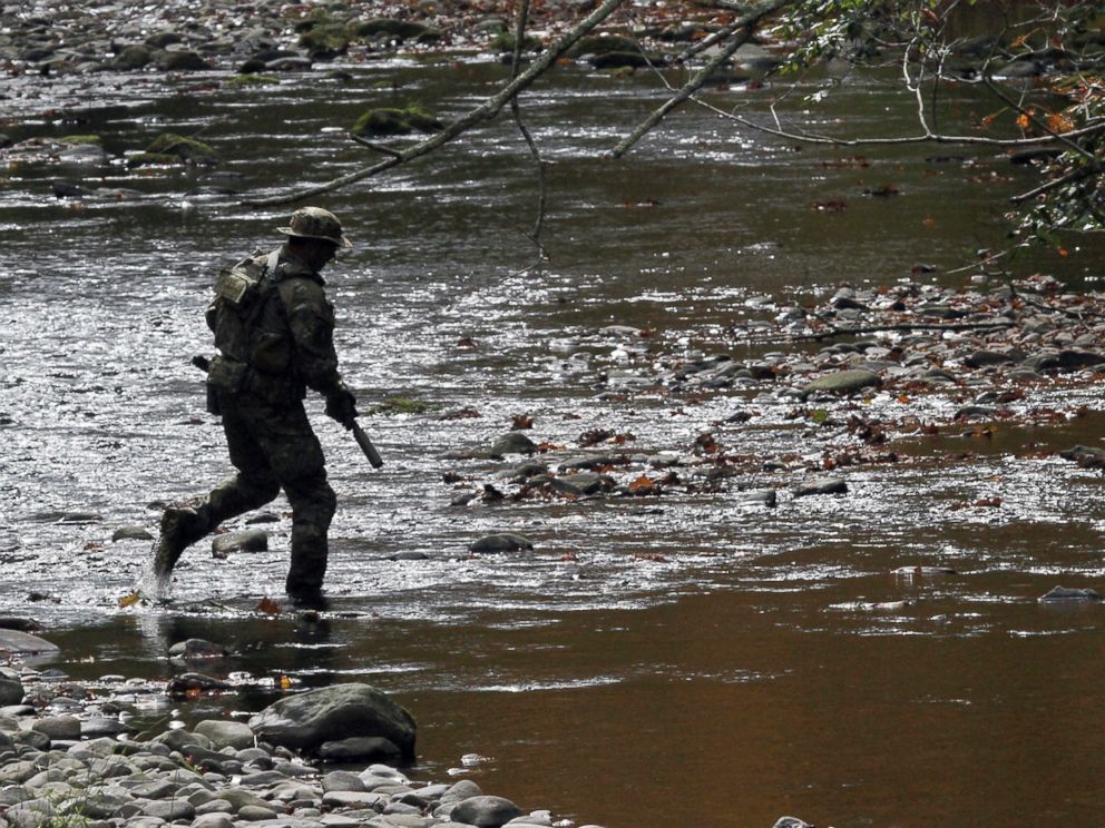 PHOTO: A U.S. marshal patrols along Mill Creek near Clarks Road in Barrett Township, Pennsylvania, Sept 29, 2014, during the search for Eric Frein.