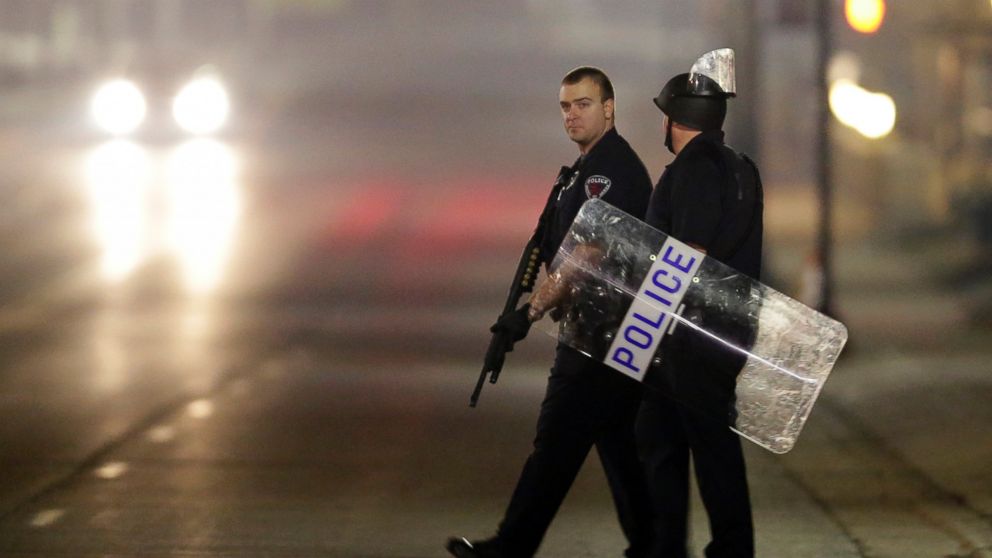 PHOTO: Police canvass the area as they investigate the scene where two police officers were shot outside the Ferguson Police Department, March 12, 2015, in Ferguson, Mo.