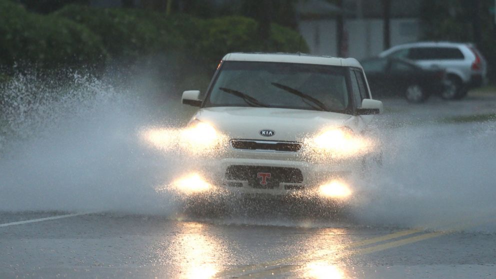 PHOTO: A vehicle drives through heavy flooding on Thomas Drive during rush hour in Panama City, Fla.