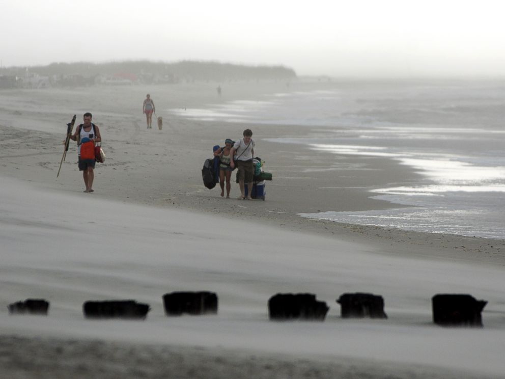 PHOTO: Clouds and rains move in as beachgoers leave Freeman Park at the north end of Carolina Beach, N.C., July 3, 2014.