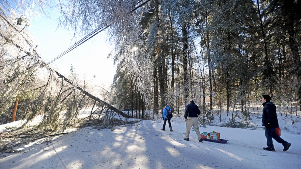 PHOTO: Chris Devine, center, hauls a sled of gifts