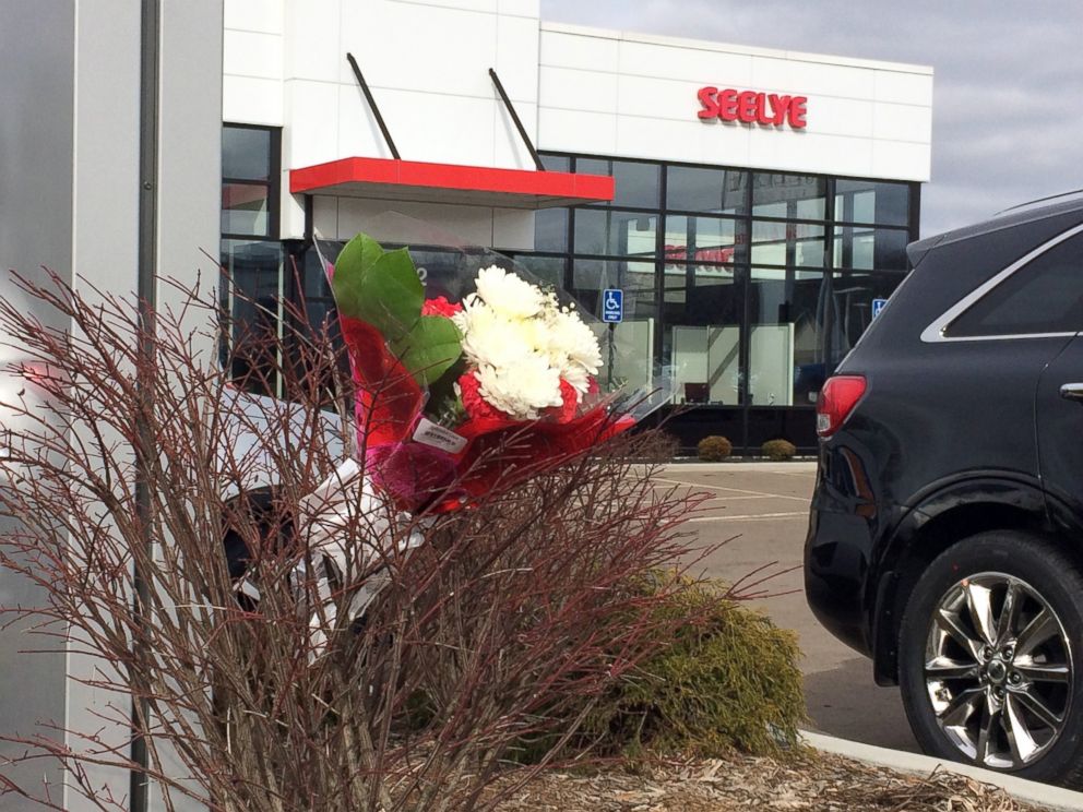 PHOTO: Flowers are place in front of a car dealership, the scene of a random shooting, Feb. 21, 2016 in Kalamazoo, Mich.