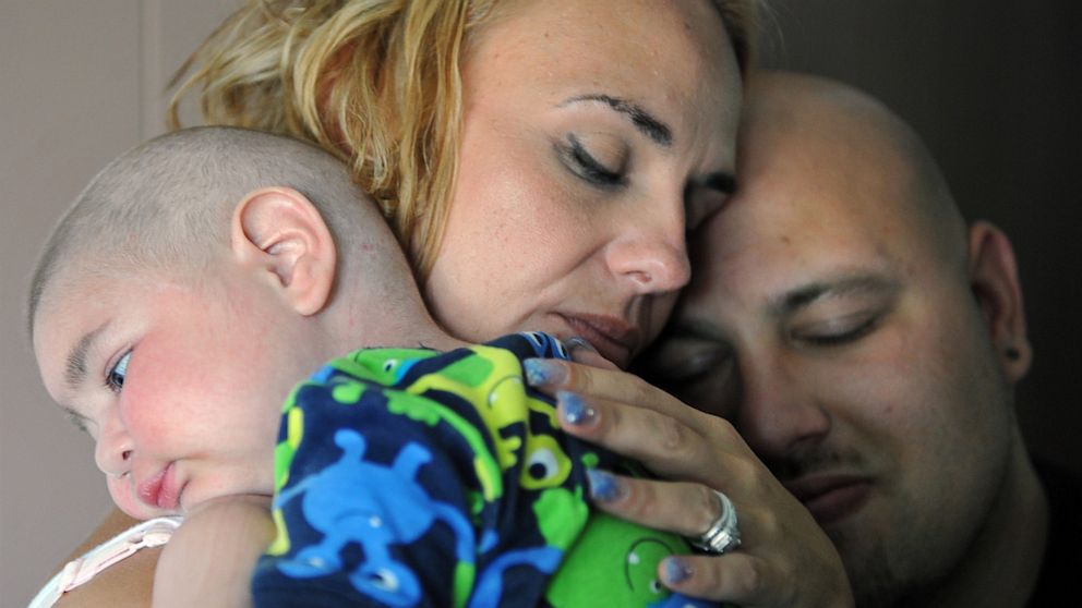 PHOTO: Christine Swidorsky holds her son, Logan Stevenson, 2, with her husband-to-be and Logans father Sean Stevenson, for a portrait on Tuesday, July 30, 2013 in their Jeannette, Pa., home.