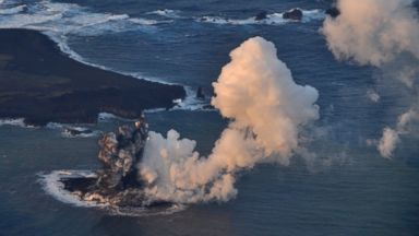 PHOTO: Smoke billows from a new island off the coast of Nishinoshima