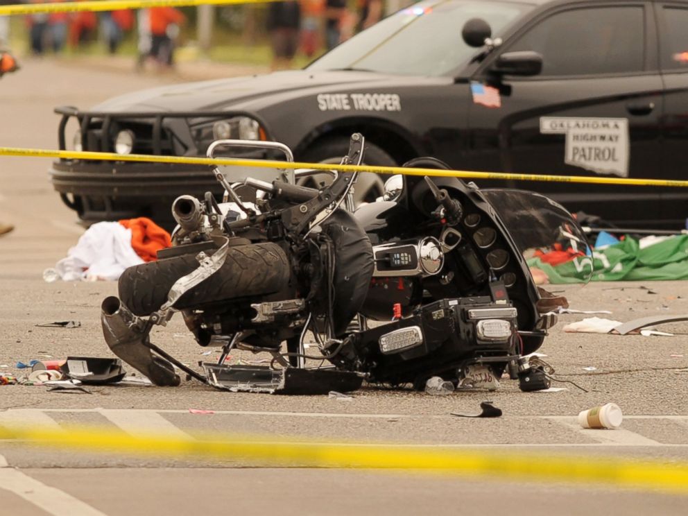 PHOTO: A damaged police motorcycle rests in the intersection after a vehicle crashed into a crowd of spectators during the Oklahoma State University homecoming parade, causing multiple injuries, Oct. 24, 2015 in Stillwater, Oka.