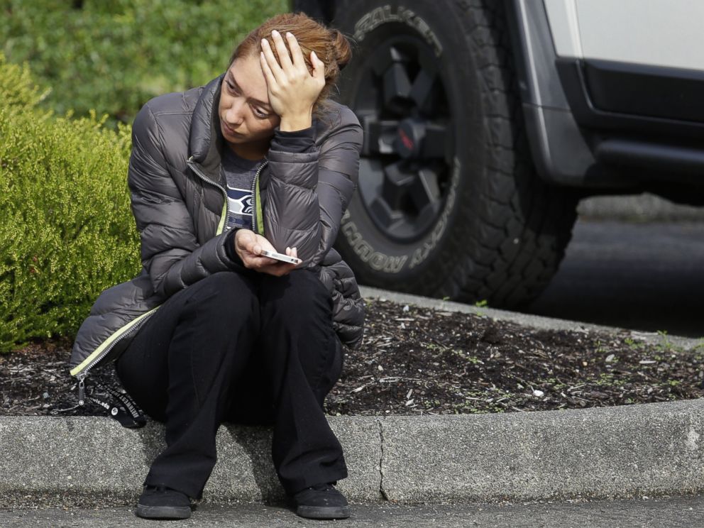 PHOTO: A woman waits on a curb at a church, where students were taken following a shooting at Marysville Pilchuck High School in Marysville, Wash. on Oct. 24, 2014.