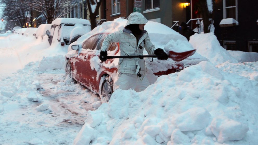 PHOTO: Liz Hall, of Albany, N.Y., digs her car out of snow in the Center Square neighborhood, Feb. 14, 2014, in Albany.