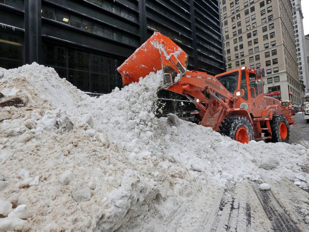 PHOTO: A New York City Department of Sanitation front end loader unloads collected snow for melting, near the World Trade Center site, in New York, Jan. 25, 2016.