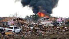 PHOTO: A fire burns in the Tower Plaza Addition in Moore, Okla., following a tornado, May 20, 2013.