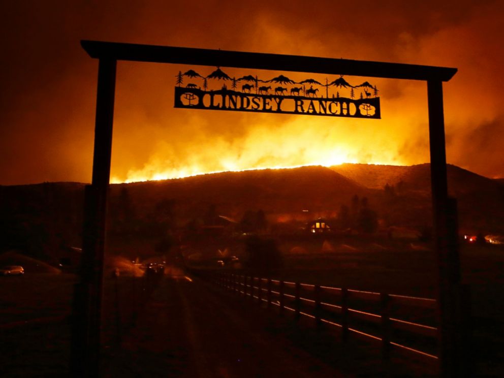 PHOTO: Fire burns on the ridge above a ranch on Twisp River Road in Twisp, Wash., Aug. 19, 2015.
