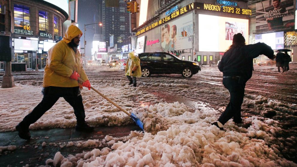 PHOTO: Snow is shoveled from a sidewalk in Times Square, Feb. 5, 2014, in New York City.
