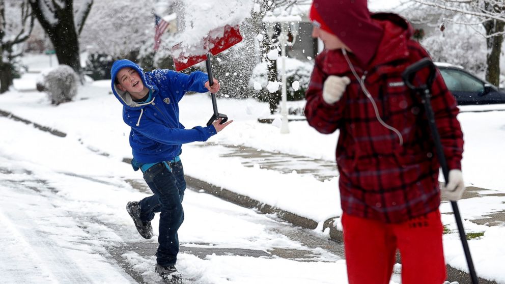 PHOTO: Austin Peters and Codi Consentino of Phillipsburg,N.J. play in the snow as they walk up John Mitchell Avenue, Dec. 10, 2013.
