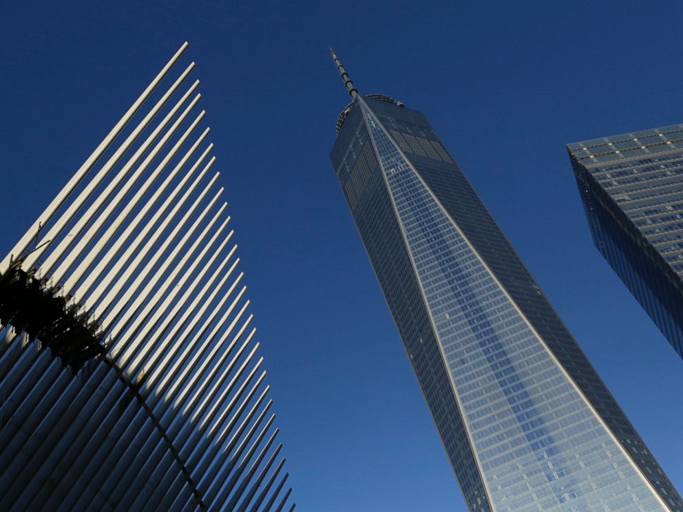 PHOTO: One World Trade Center stands between the transportation hub, left, still under construction, and 7 World Trade Center, right, Nov. 3, 2014 in New York. 