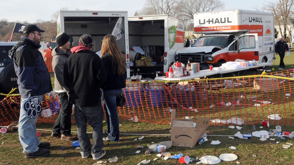PHOTO: People look at the scene of a fatal accident in a parking area outside an NCAA college football game between Harvard and Yale, in New Haven, Conn., Nov. 19, 2011.