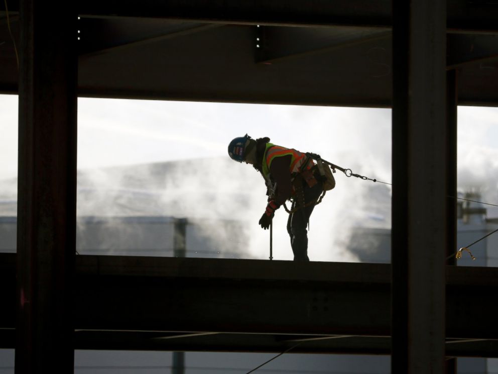 A worker braves cold temperatures while working atop steel beams at the Albany convention center project on Feb. 12, 2016, in Albany, N.Y.