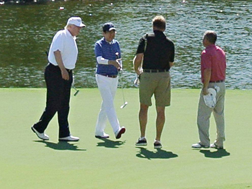 PHOTO: President Donald Trump, wearing black pants, and Japans Prime Minister Shinzo Abe, third from right, enjoy playing golf, Feb. 11, 2017, in Florida.