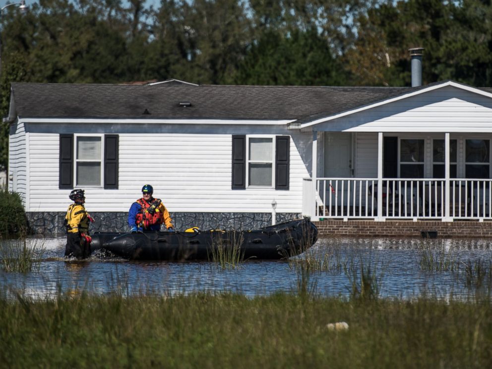 PHOTO: Rescue workers navigate floodwaters in a neighborhood, on Oct. 10, 2016, in Lumberton, North Carolina. 