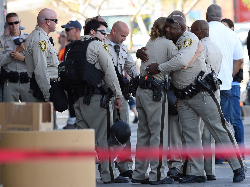 PHOTO: Las Vegas Metropolitan Police Department officers hug near a Wal-Mart on June 8, 2014 in Las Vegas, Nevada. Two officers were reported shot and killed by two assailants at a pizza restaurant near the Wal-Mart.