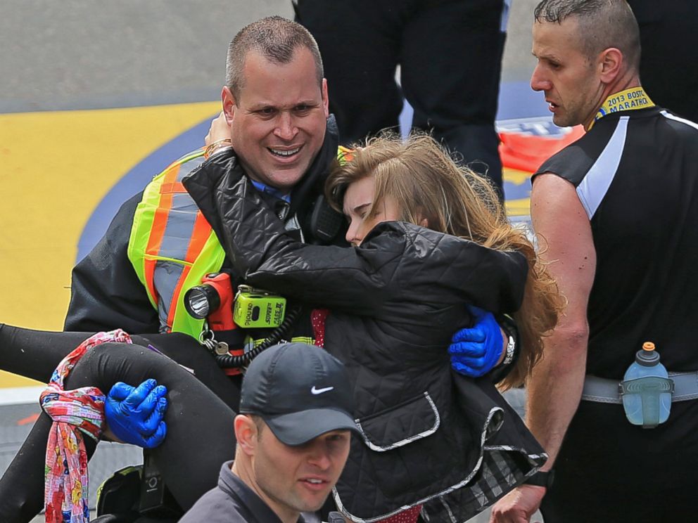 PHOTO: Victim Victoria McGrath is helped to a stretcher by emergency personnel after two explosions went off near the finish line of the 117th Boston Marathon on April 15, 2013.