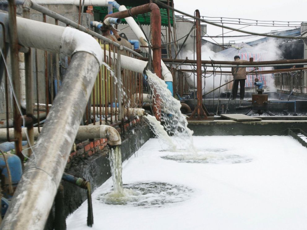 PHOTO: Pipes emit waste water into a wastewater treatment pond at a garments factory, Dec. 5, 2005 in Chengdu of Sichuan Province, China.