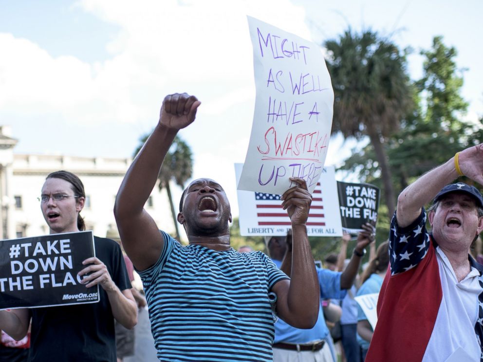 PHOTO: People gather to protest the confederate flag which flies in front of the South Carolina Statehouse in Columbia, S.C., June 20, 2015.