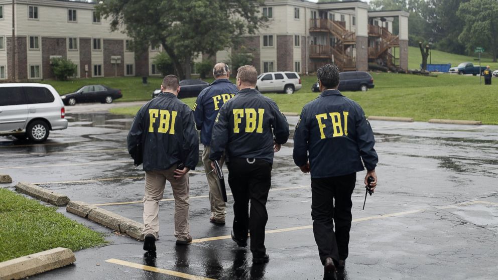 PHOTO: FBI Agents are seen in this Aug. 16, 2014 file photo investigating the shooting death of 18-year-old Michael Brown at the location where he was killed on Canfield Drive in Ferguson, Mo.