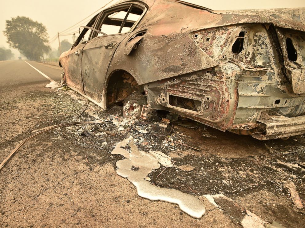 PHOTO: Melted metal flows from a burned out car abandoned on a highway near the Valley fire in Middletown, Calif., Sept. 13, 2015.