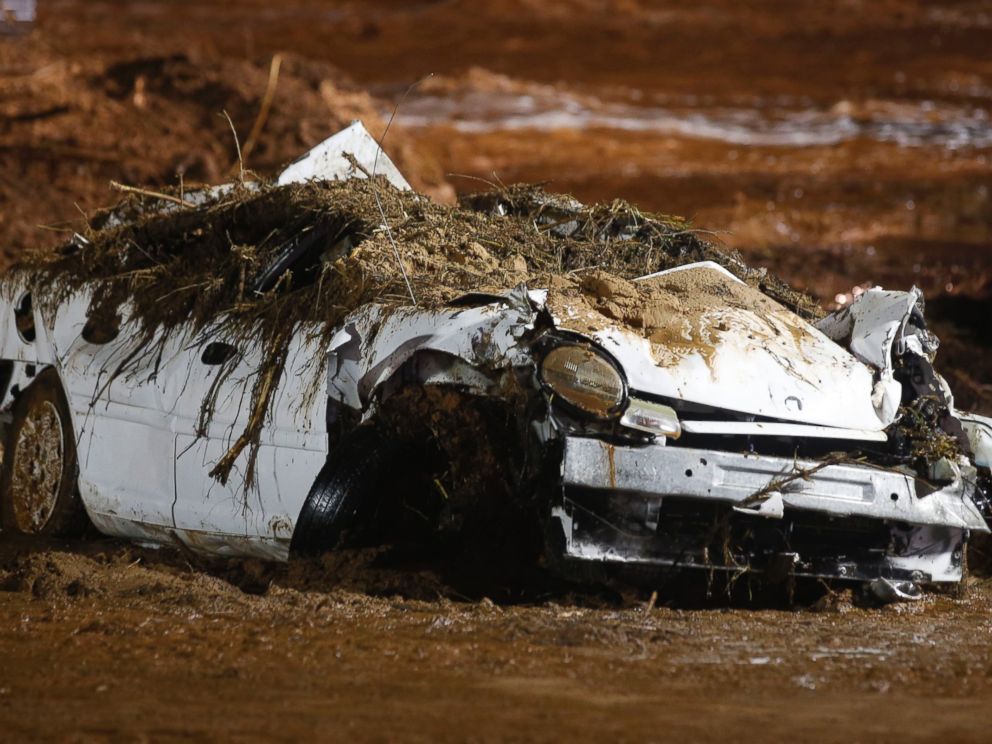 PHOTO: A car sits on the side of the road after being pulled from Short Creek by construction equipment that is removing flood debris from Short Creek as it crosses Central Street, Sept. 15, 2015 in Hildale, Utah