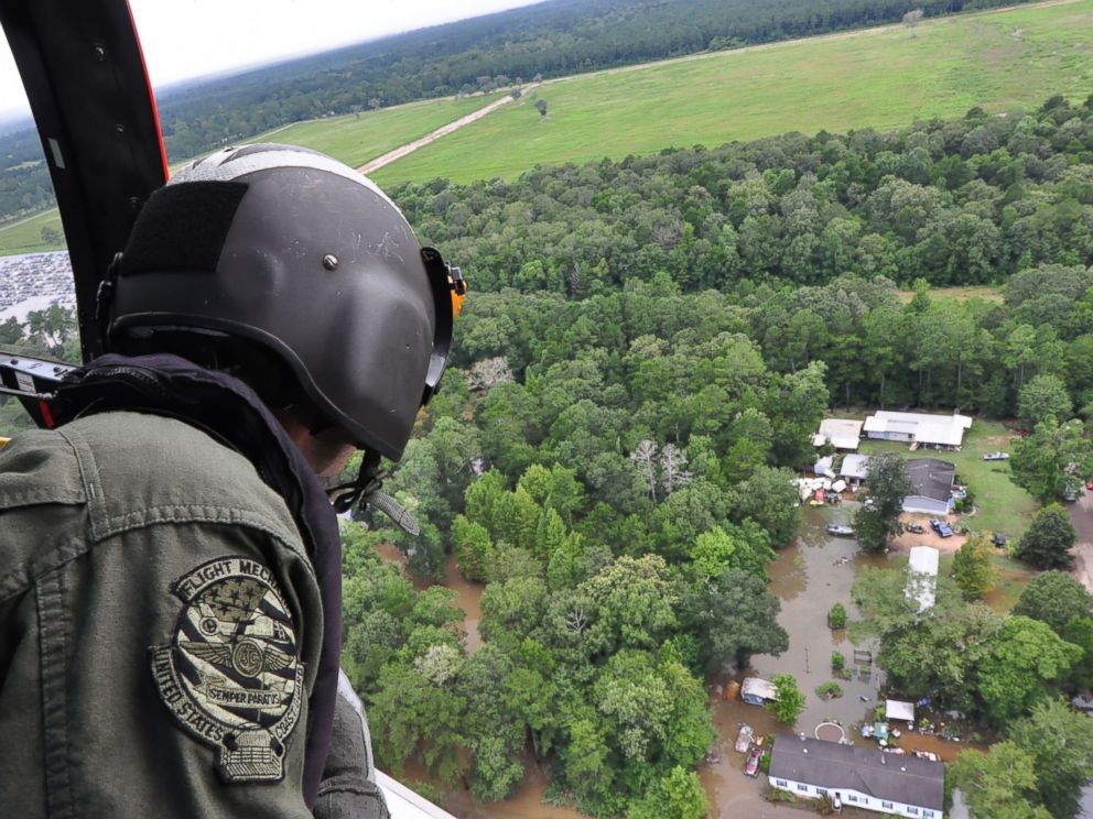 PHOTO: A Coast Guard crew searches by helicopter for people who may need assistance in flooded areas of Baton Rouge, Louisiana, Aug. 15, 2016.