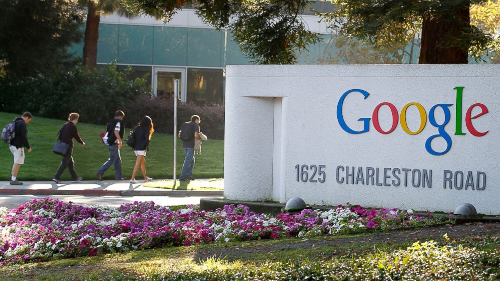 PHOTO: Employees walk past Google Inc. signage at company headquarters in Mountain View, Calif., Oct. 13, 2011.