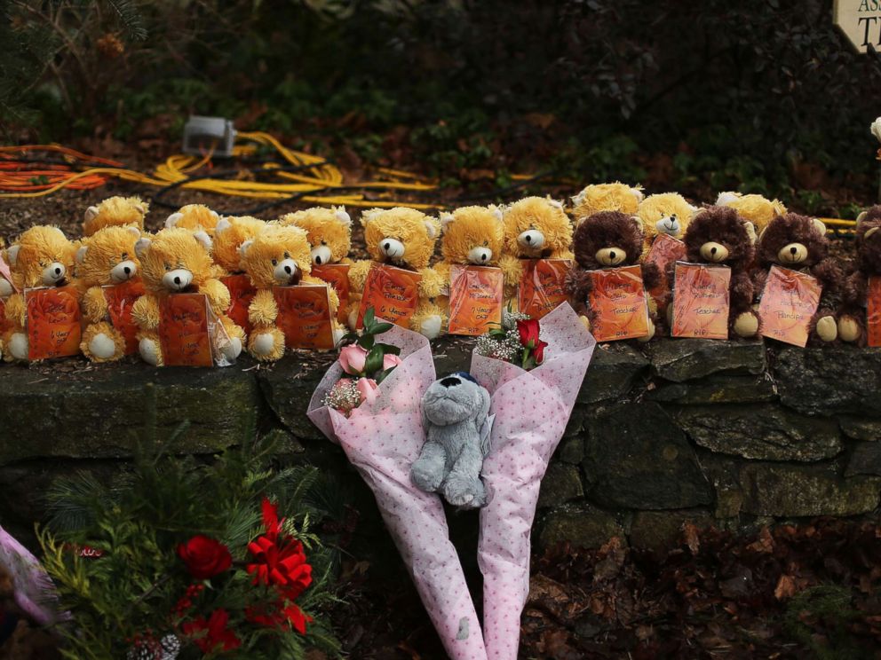 PHOTO: Teddy bears and flowers, in memory of those killed, are left at a memorial down the street from the Sandy Hook School on Dec. 16, 2012 in Newtown, Conn.